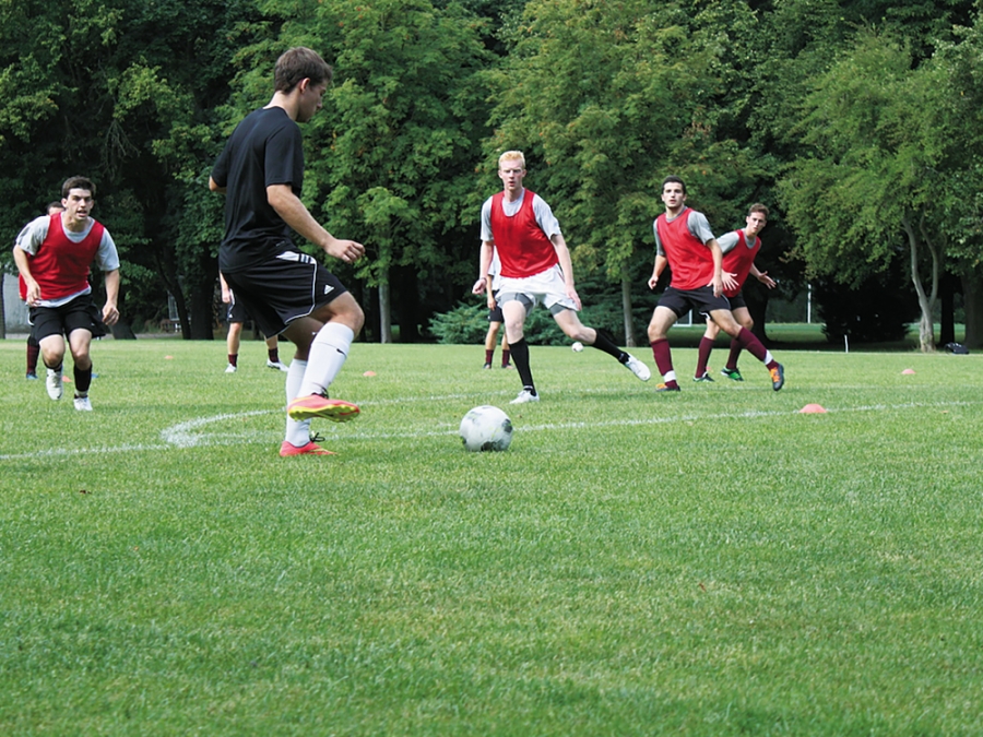 Soccer players practicing in red jerseys